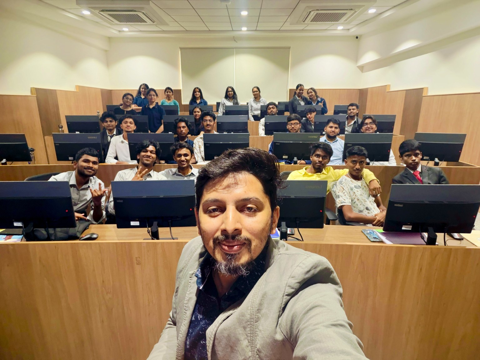 Vikram with students in a computer classroom